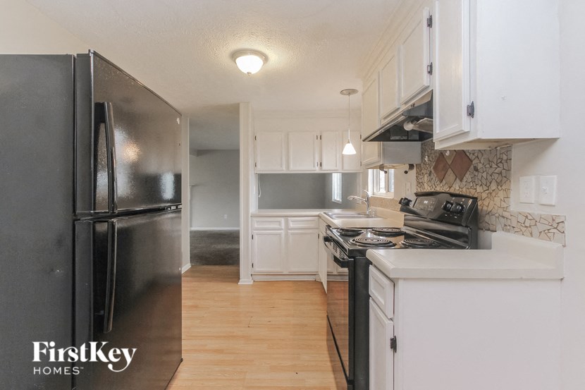 a kitchen with stainless steel appliances and white cabinets