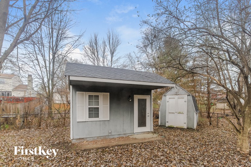 the tiny house has a shed and a white door