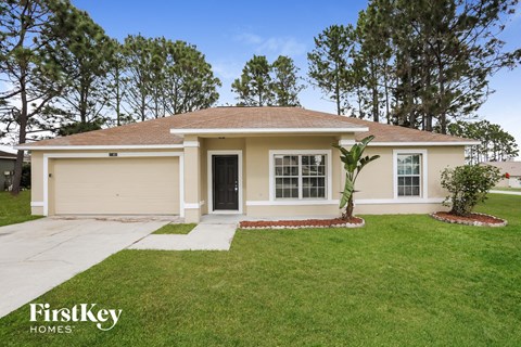 the exterior of a home with a lawn and a sidewalk
