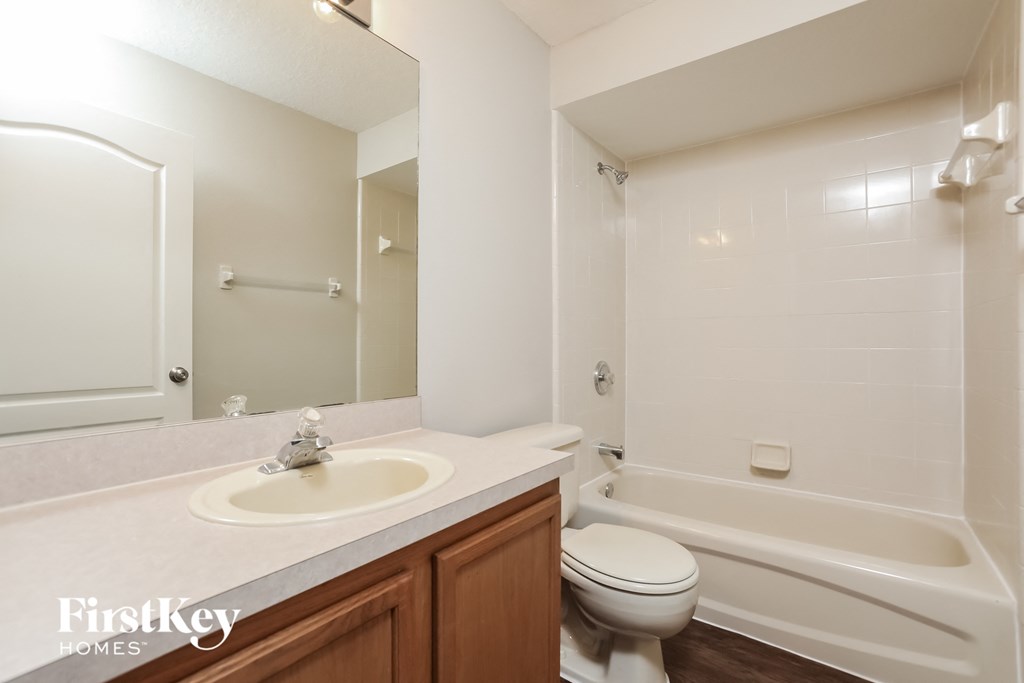 a bathroom with a sink toilet and a tub
