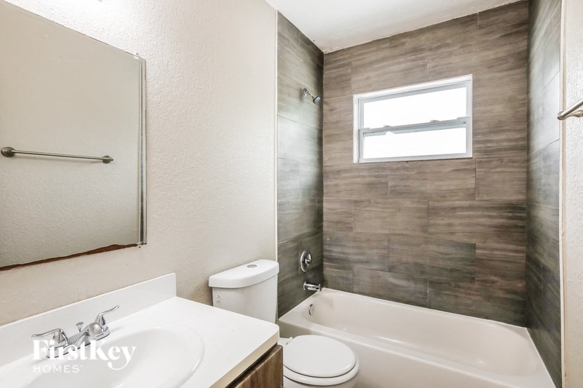a bathroom with a shower toilet and sink and a bath tub