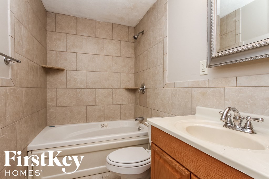 a bathroom with a tub and a sink and a toilet