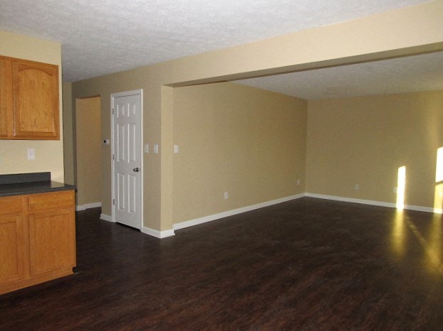 A room with wooden floors and a white door.