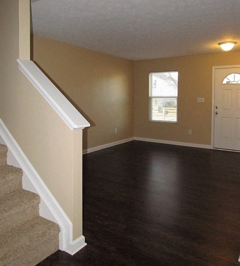 A room with a staircase leading to the upper floor.