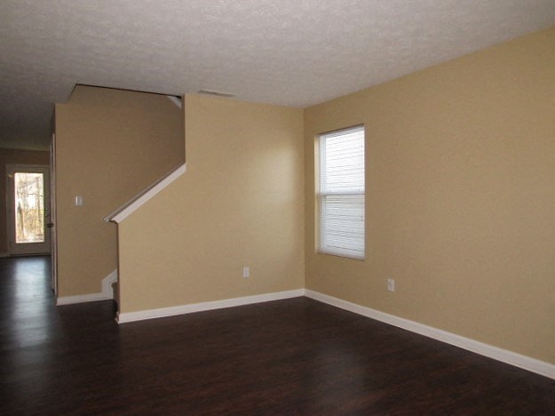 A room with a staircase and a window.