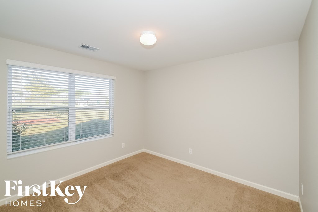 the second bedroom is spacious and has a large window