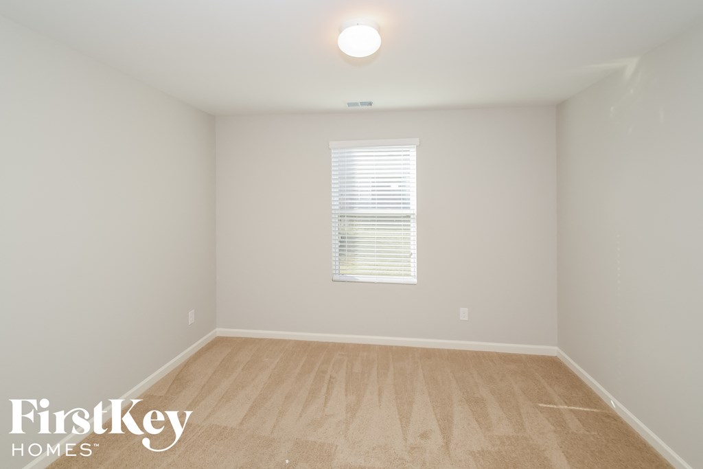 a white room with a wooden floor and a window