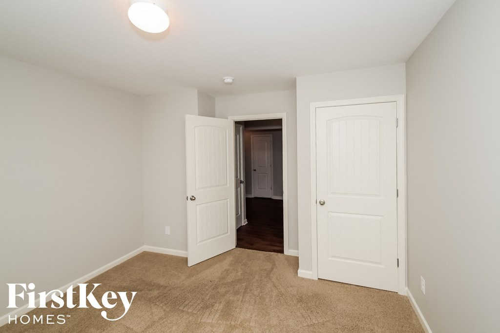a bedroom with two closets and a door to a hallway