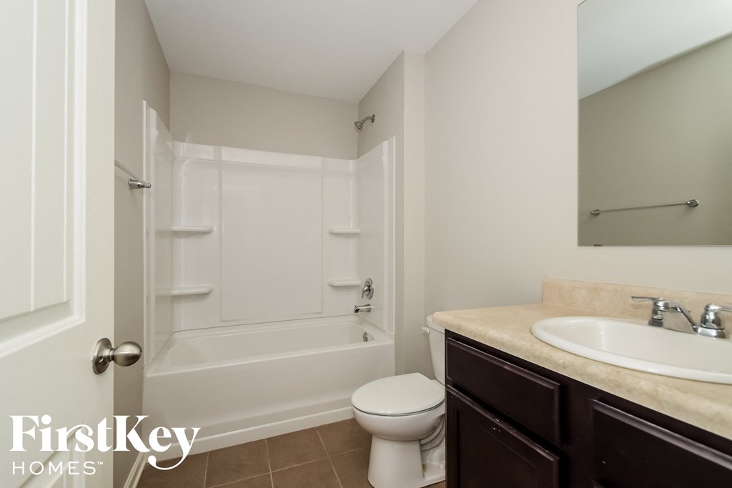 a bathroom with a sink toilet and a tub