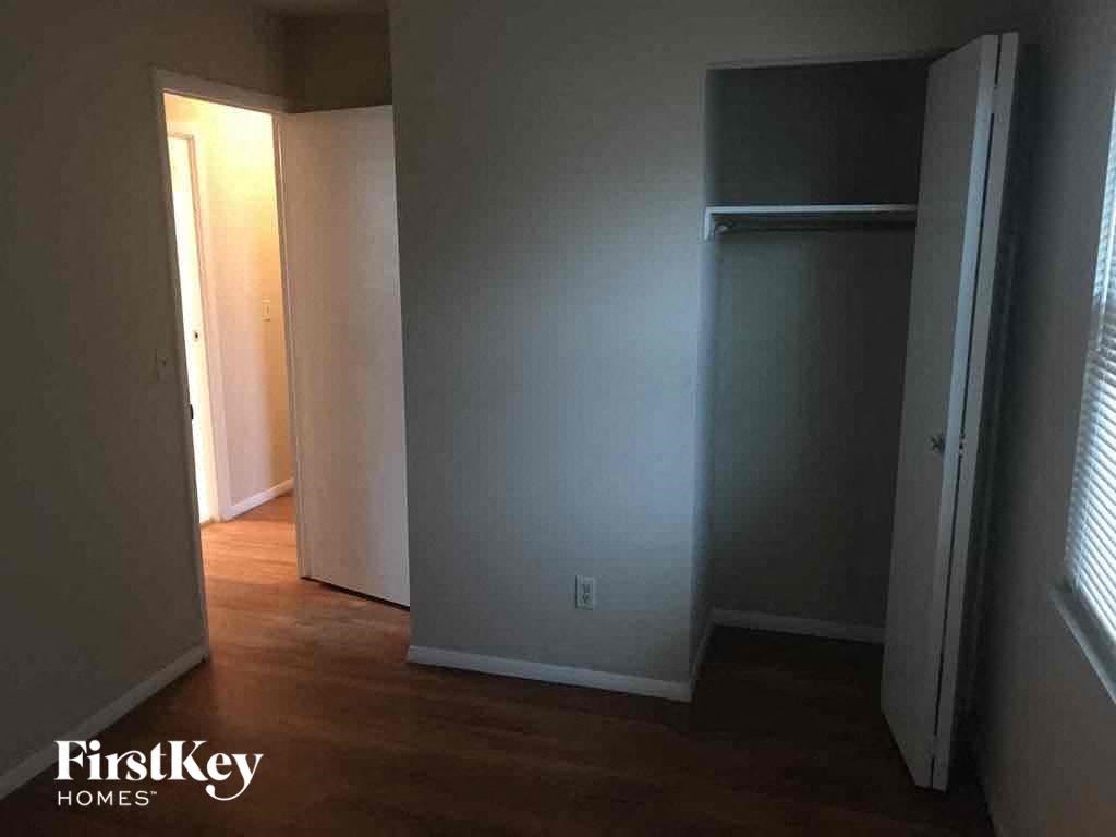 A room with a wooden floor and a white door.