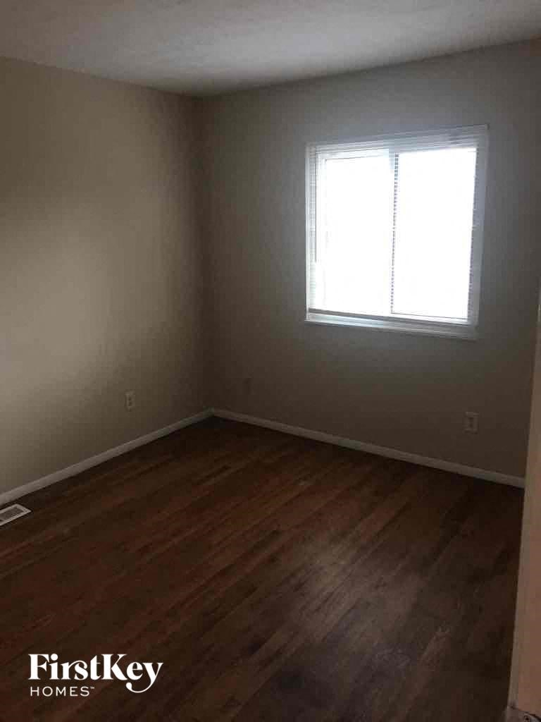 A room with wooden floors and a window.