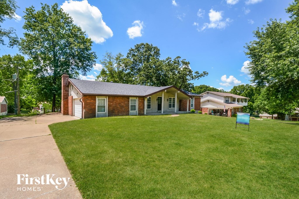 A house with a lawn in front of it.