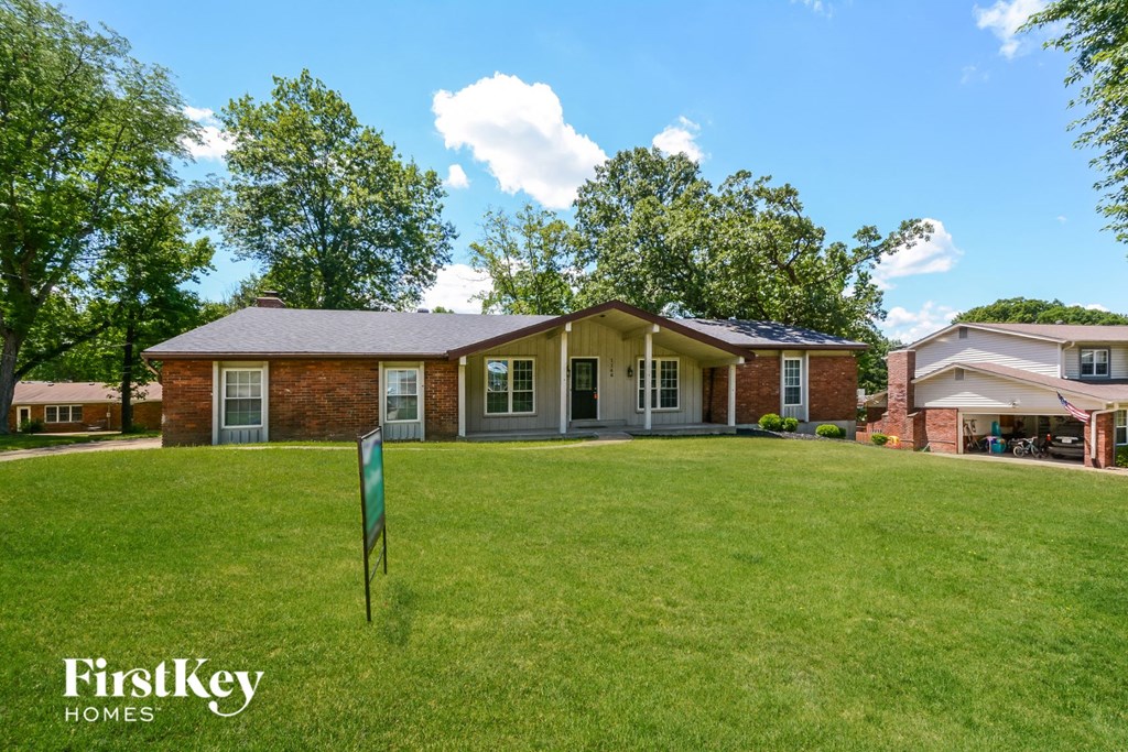 A house with a lawn in front of it and a sign that says FirstKey Homes.