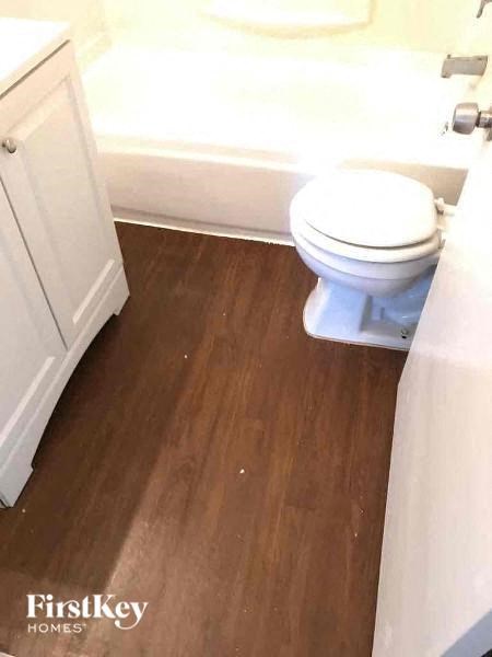 a bathroom with a toilet and a bath tub