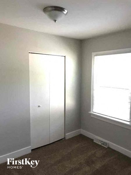 a white room with a window and a closet