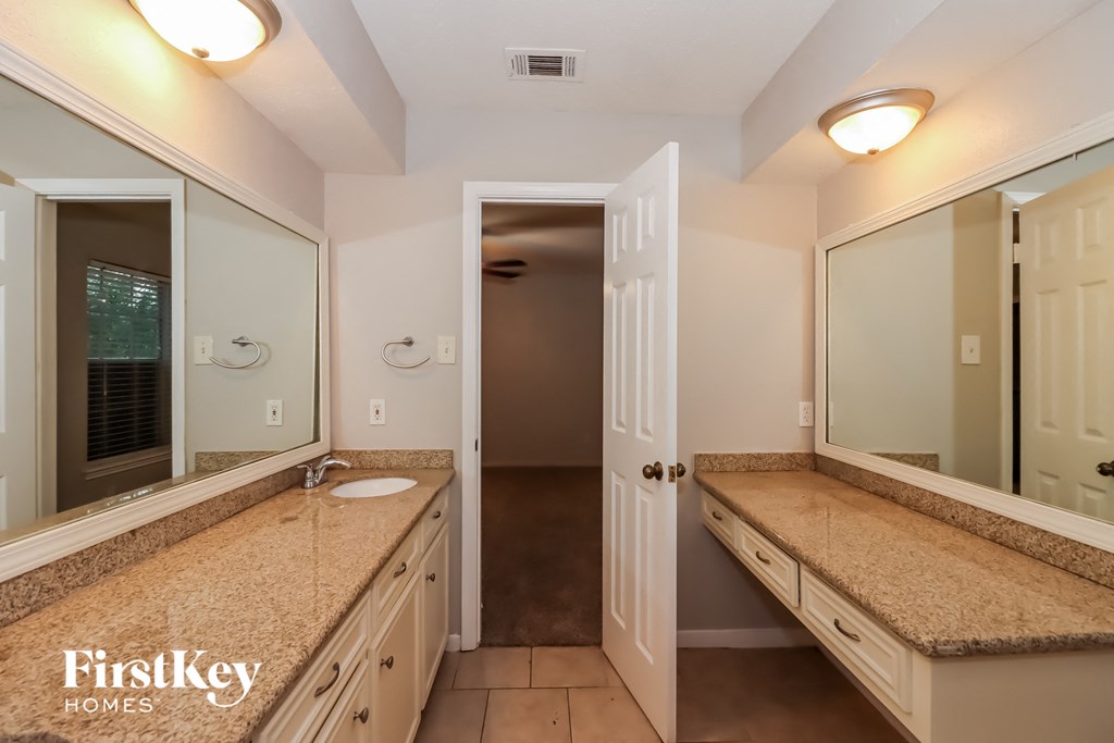 a bathroom with two sinks and a large mirror