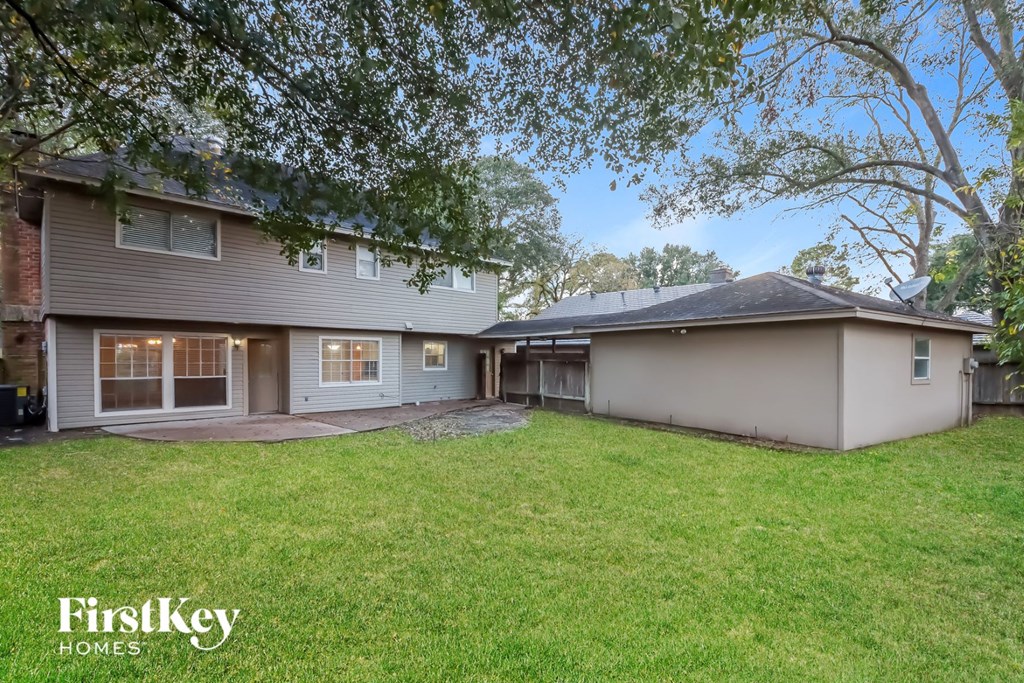 a renovated house with a yard and a garage