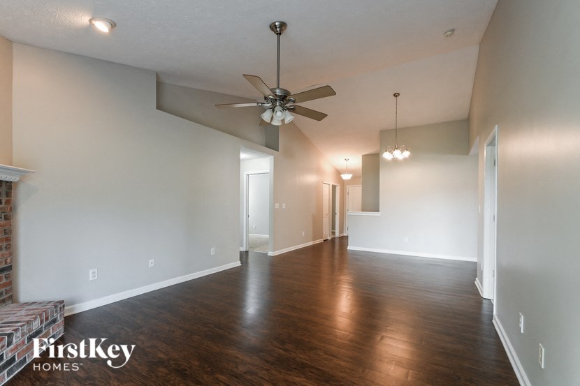 a living room and dining room with a ceiling fan