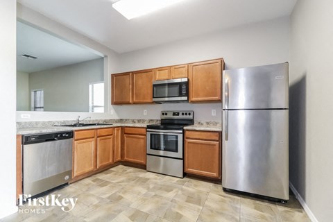 A kitchen with wooden cabinets and stainless steel appliances.