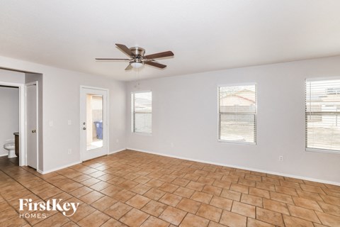 a living room with a ceiling fan and a tile floor