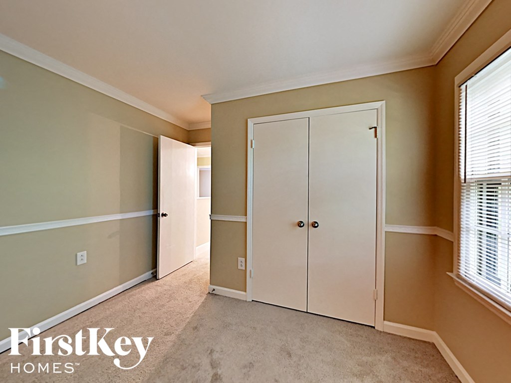 a bedroom with two closets and a window