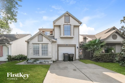 a white house with a garage and a driveway