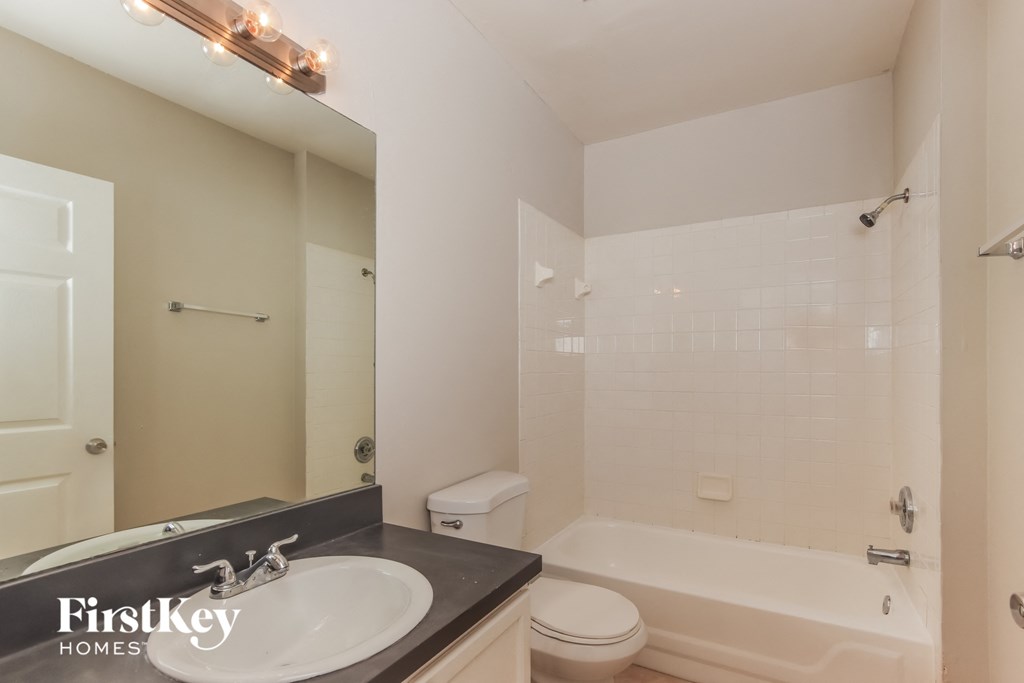 a bathroom with a sink and a tub and a toilet