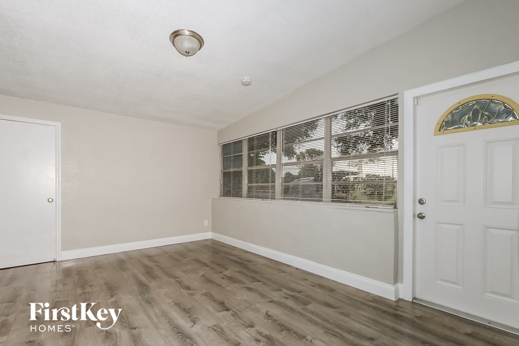 A room with a wooden floor and a white door.