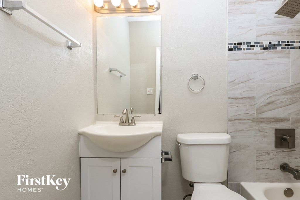 A white sink and toilet in a bathroom.