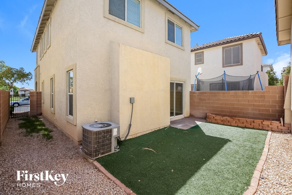 a backyard with a green lawn and a house