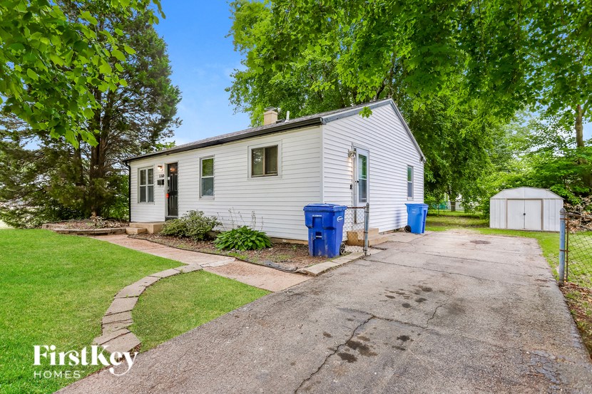 A house with a driveway and a garage is for sale.
