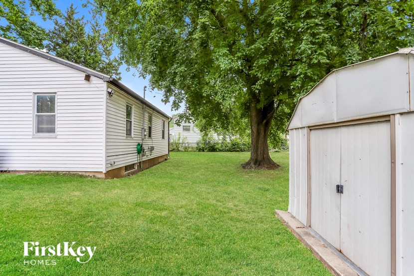 A FirstKey Homes sign is on a white house.