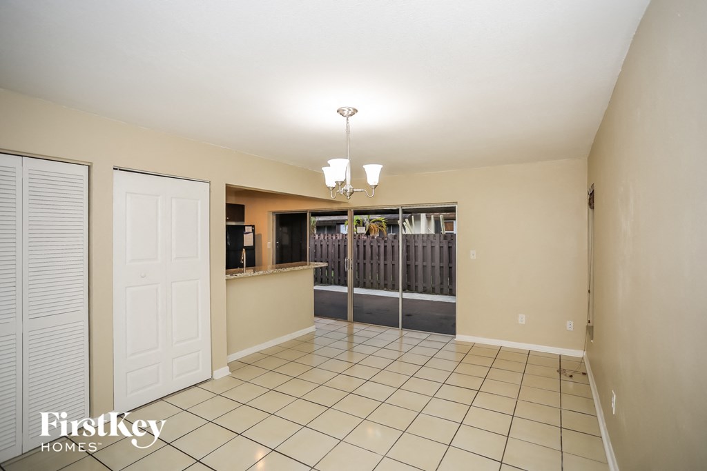 a kitchen and living room with a door to a patio