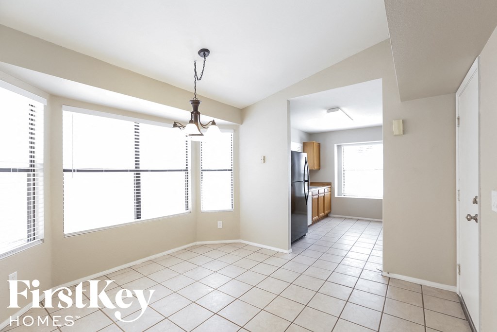 an empty kitchen and living room with a large window
