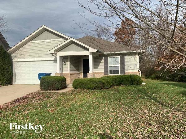A house with a garage and a driveway is for sale.