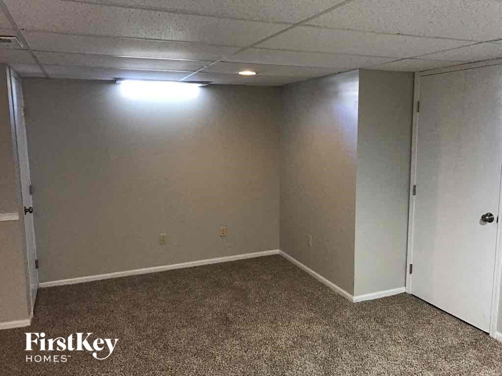 an empty room with a white wall and a door