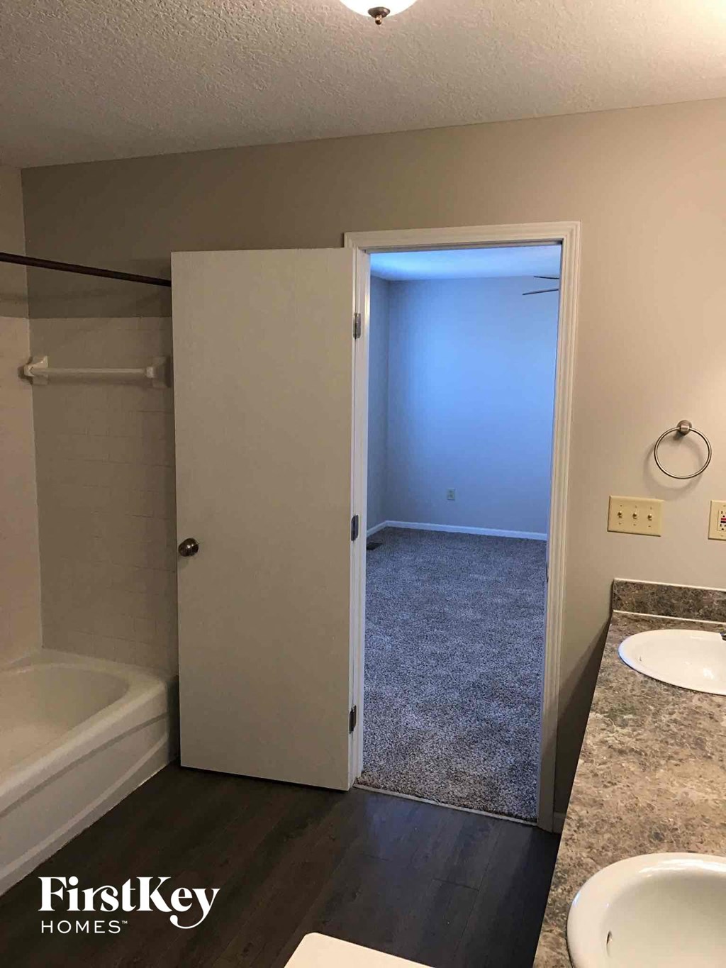 a bathroom with a shower and a sink and a mirror
