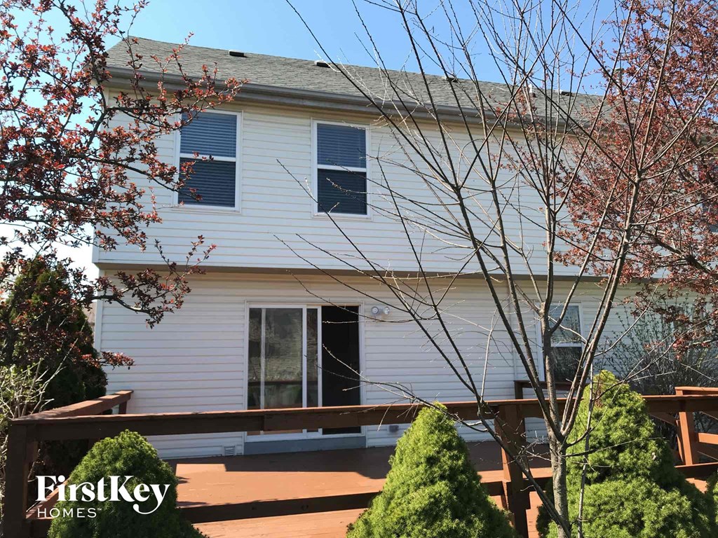 a white house with a deck in front of it