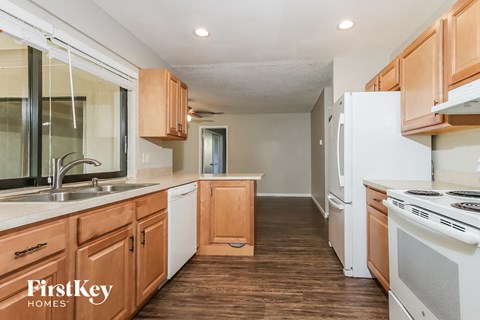 A kitchen with wooden cabinets and a white refrigerator.