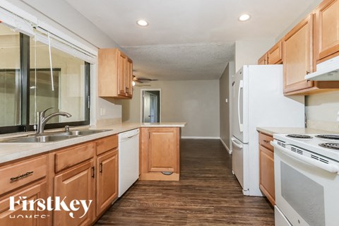 A kitchen with wooden cabinets and a white refrigerator.