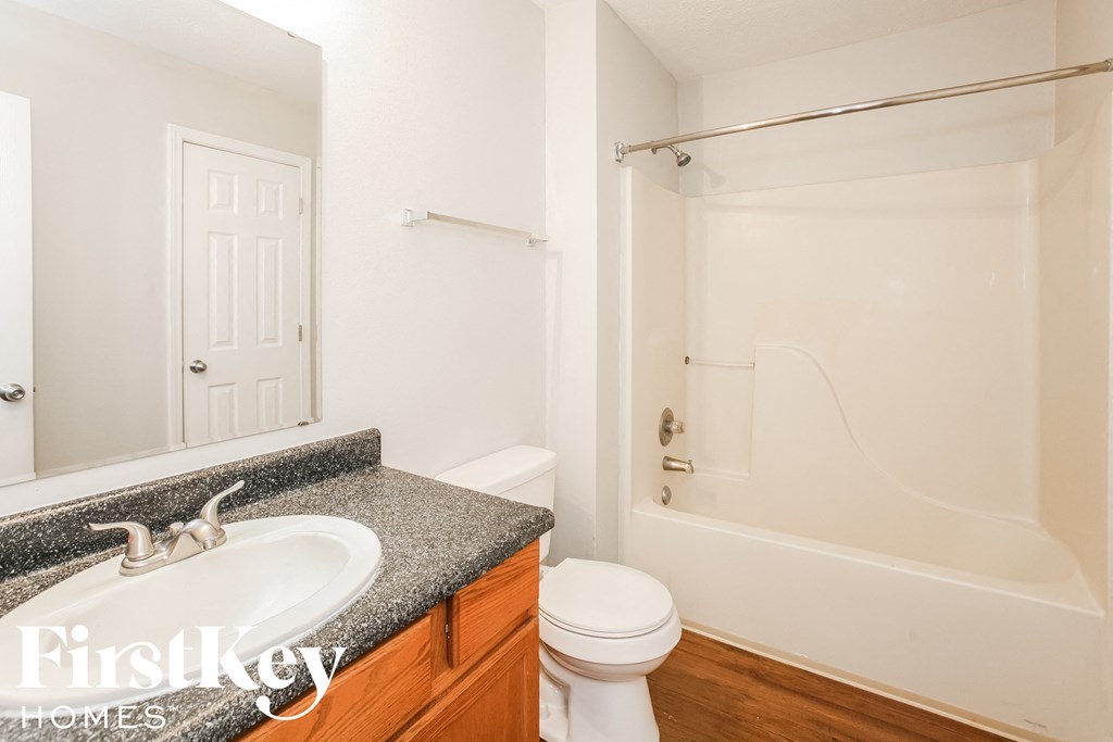 a bathroom with a sink and a toilet and a shower