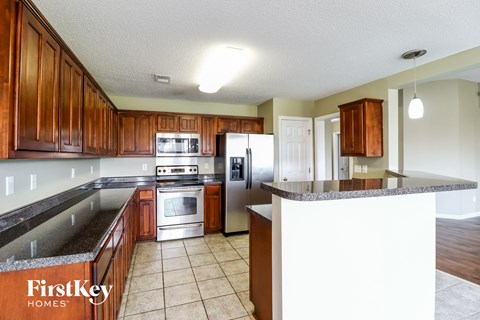 a kitchen with wooden cabinets and stainless steel appliances