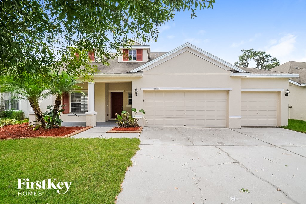 a white house with a driveway and a garage door