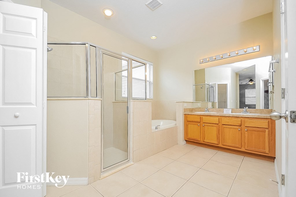 a bathroom with a shower and a sink and a mirror
