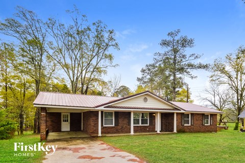 front view of a brick house with a metal roof