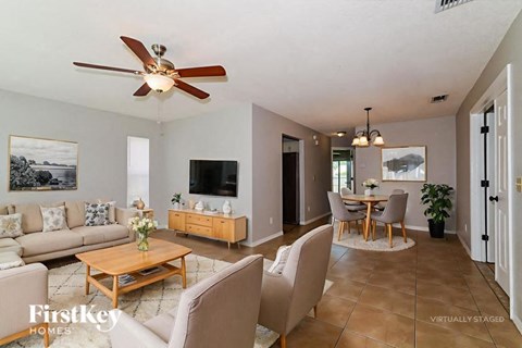 A living room with a ceiling fan and a couch.