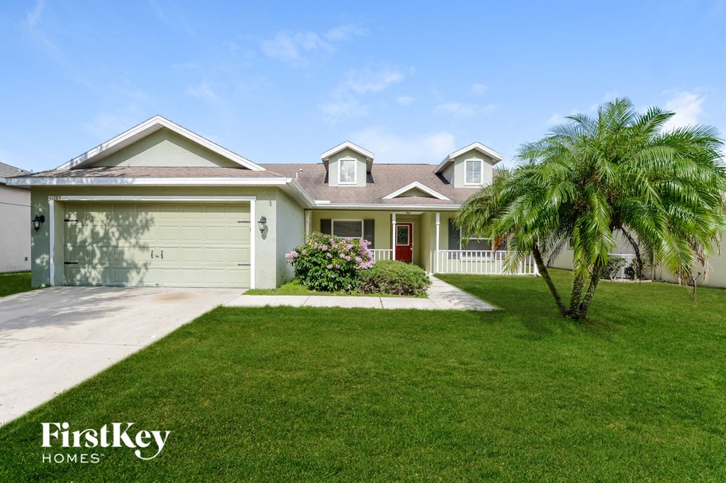 A house with a palm tree in front of it.