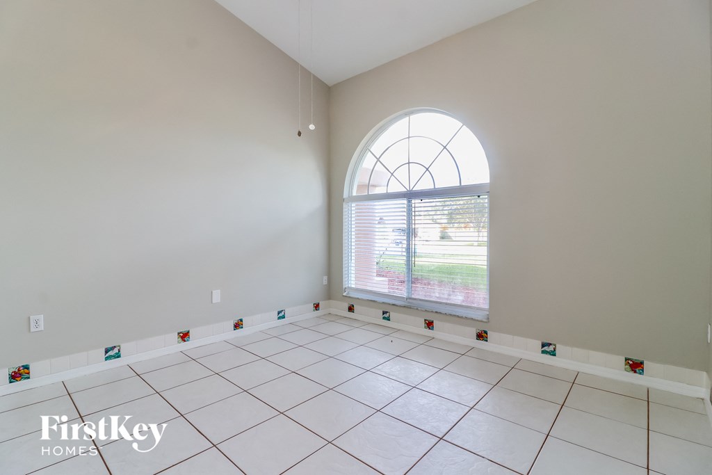 the living room of an empty house with a large window