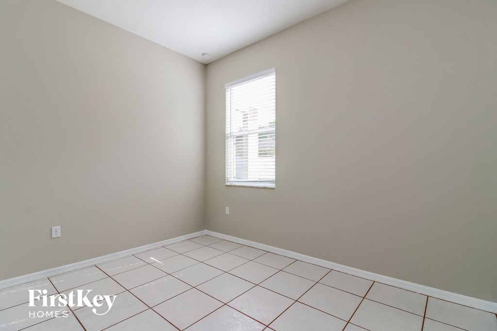 a empty room with a window and a tiled floor