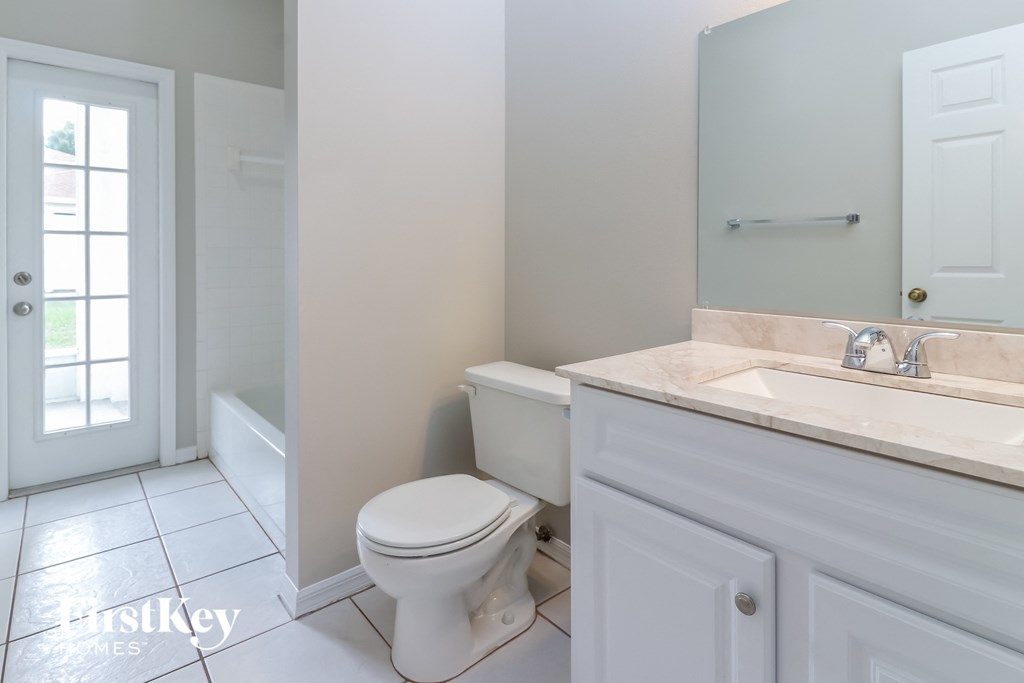 a bathroom with a toilet and a sink and a tub
